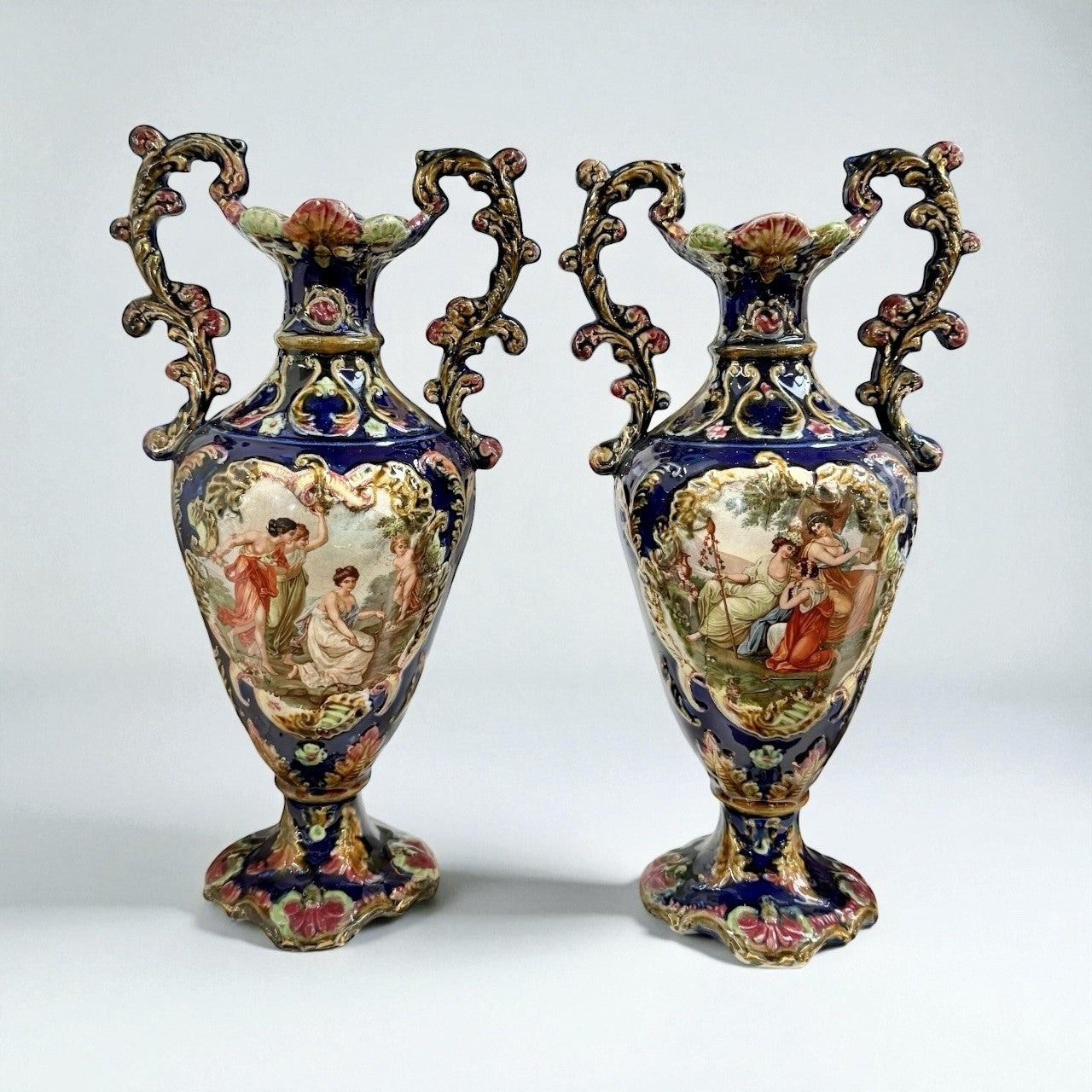 Pair of Antique Rococo Style Hand Painted Porcelain Urns with Figural Scene