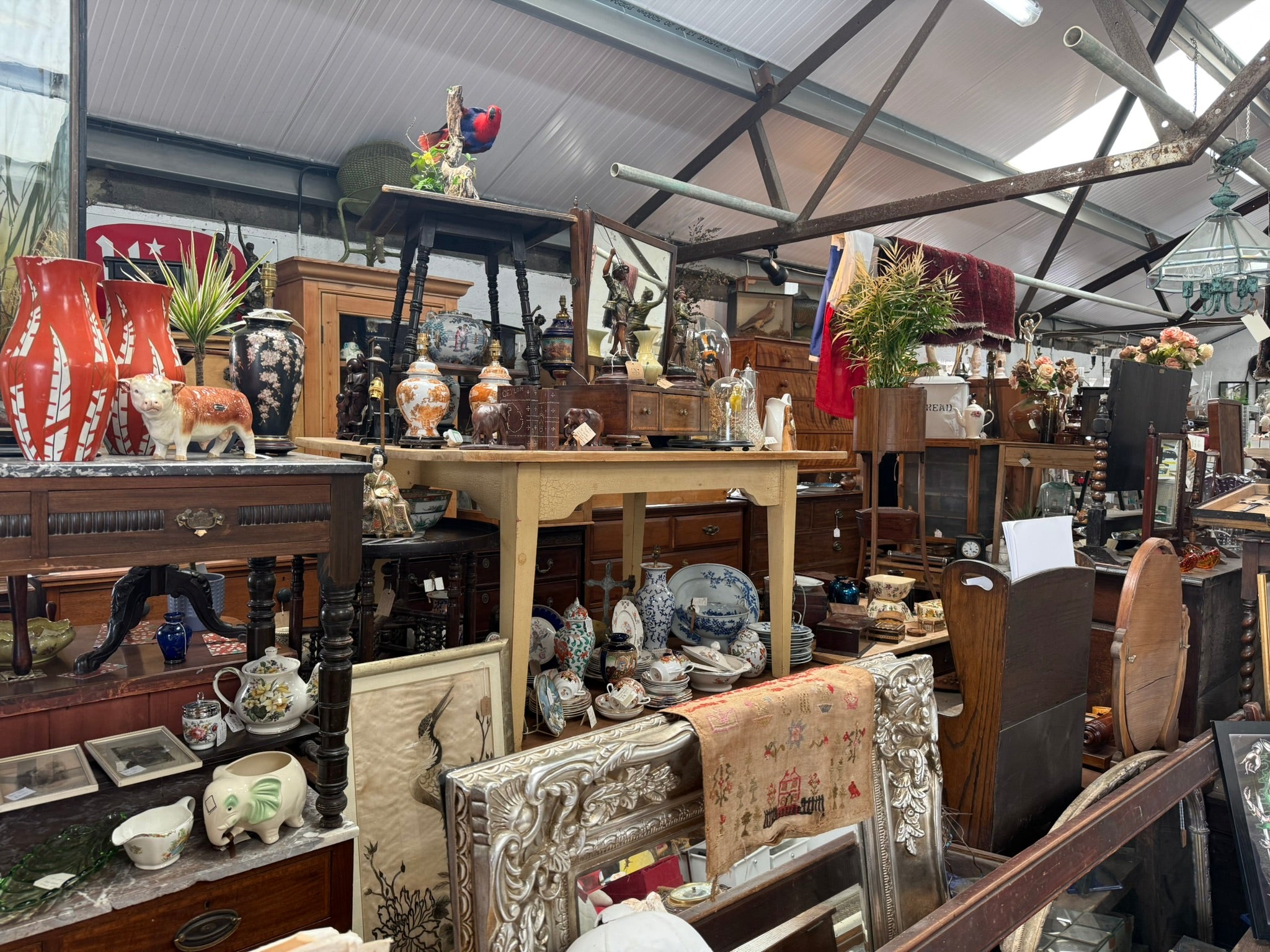Antique furniture, artwork and decorative objects inside The Cow Shed Collective